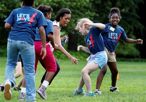 Michelle Obama playing flag football with young girls as part of her Let's Move Campaign
