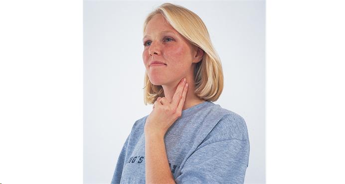 Woman monitoring pulse on neck  