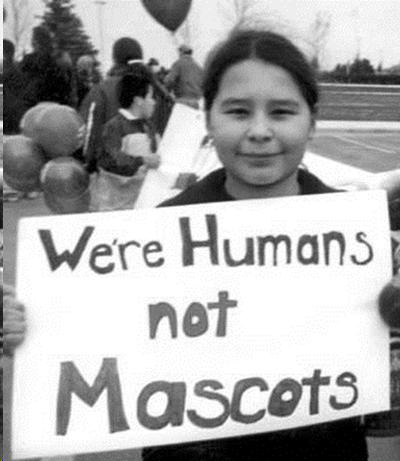 Young girl protesting "We are Humans not Mascots"  